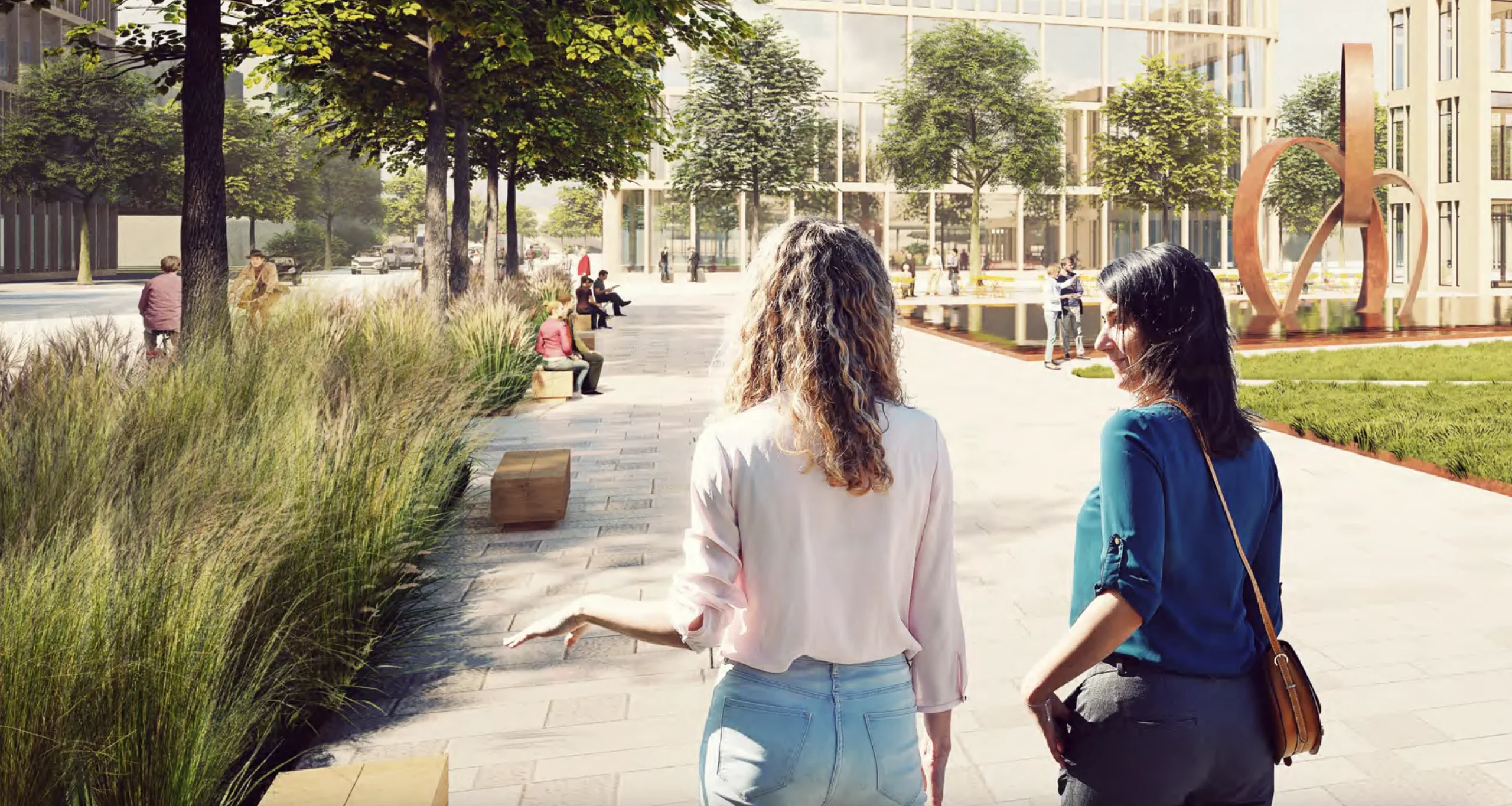 two women walking at a city park with a fountain, benches, trees, and buildings around